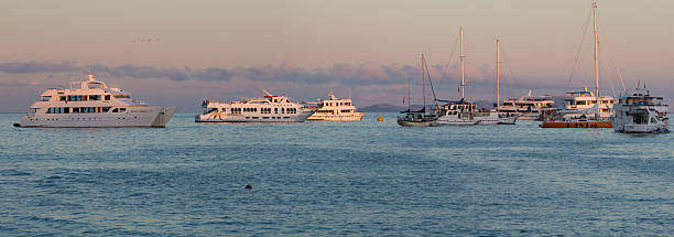 Sunset and cruise ships in Galapagos Islands stock photo