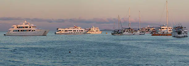 GALAPAGOS ISLANDS, ECUADOR - FEBRUARY 12: Sunset and cruise ships in the port of Puerto Ayora. Galapagos Islands, Ecuador on February 15, 2015
