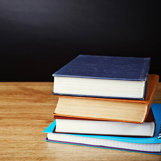 istock books on wooden deck table and grunge background 482950993