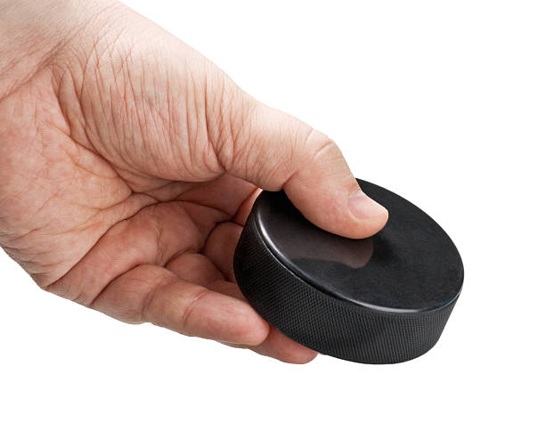 istock hockey puck in his hand 482951193