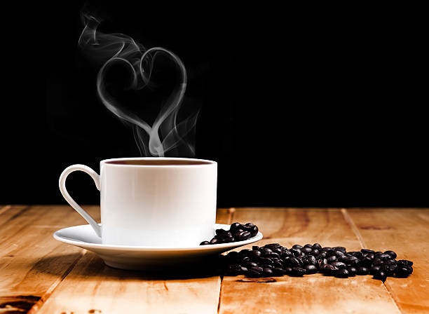istock White coffee cup on wooden table and dark background 482951739