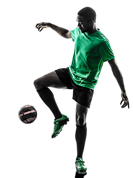 istock african man soccer player juggling silhouette 482951799