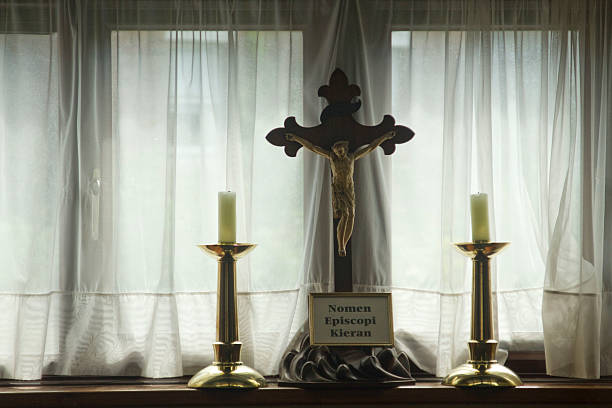 istock Crucifix in front of net curtain windows 482953367