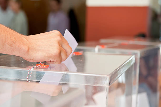 Voting Unrecognizable person putting paper in sealed  transparent box, voting for elections, shallow doff ballot box photos stock pictures, royalty-free photos & images