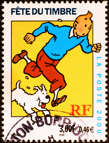 Milan, Italy - July 30, 2015: french postage stamp with an illustration of the comic book characters Tintin and his pet fox terrier Snowy.