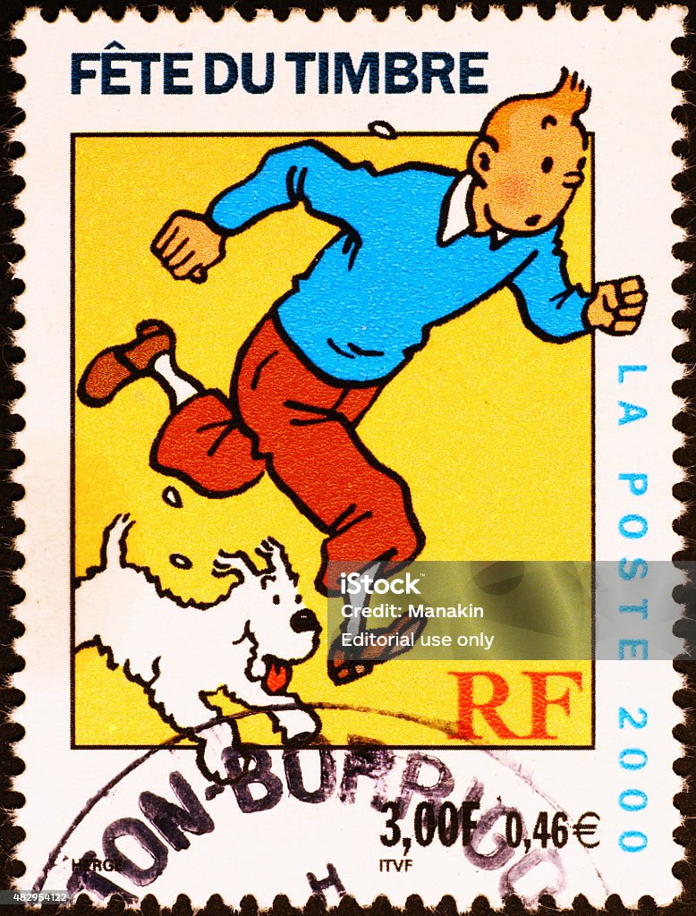 Comic book character Tintin on french postage stamp Milan, Italy - July 30, 2015: french postage stamp with an illustration of the comic book characters Tintin and his pet fox terrier Snowy. Tintin Stock Photo