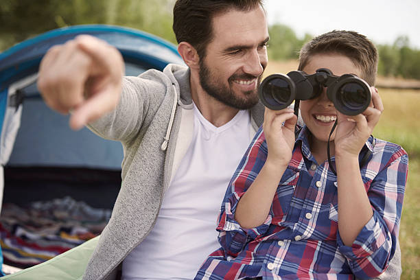 istock Boy and his father enjoying the views on camping 482957756