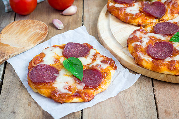 istock Homemade mini pepperoni pizza on a wooden board 482958774