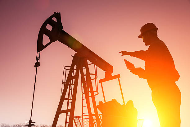istock Silhouette of a oil drill worker 482963919
