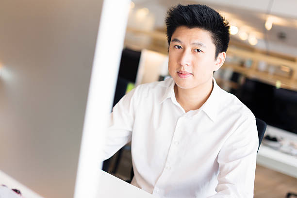 istock young asian office worker at his desk 482964443