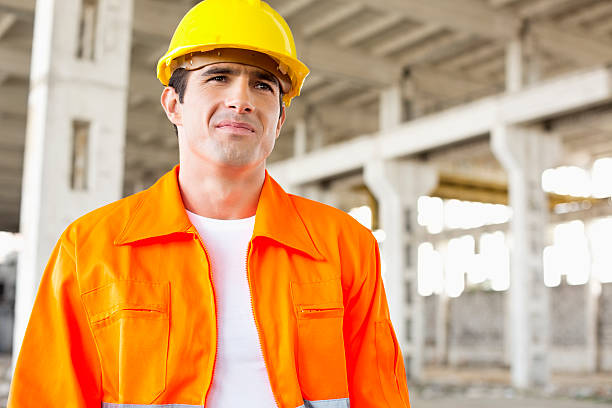 istock Handsome mid adult man wearing protective workwear at construction site 482964827