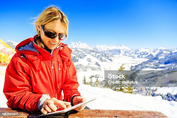 Mature Woman With Digital Tablet Stock Photo - Download Image Now - Digital Tablet, Sunlight, Winter