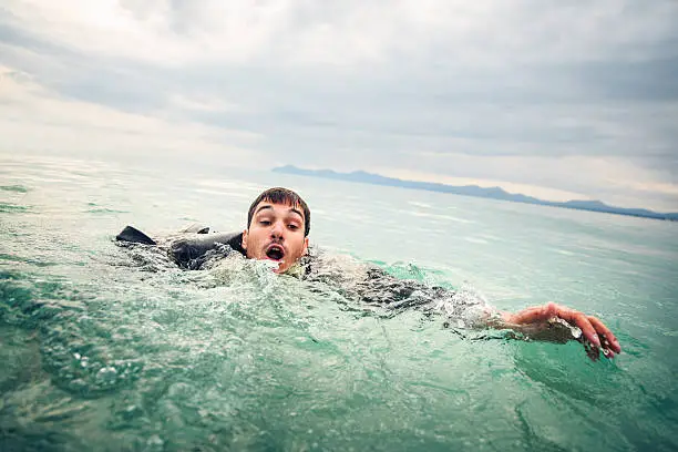 businessman drowning in the open sea