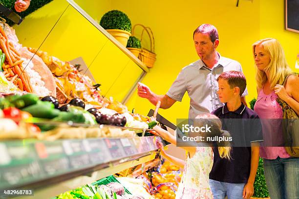 Family At The Supermarket Stock Photo - Download Image Now - 40-49 Years, Adult, Aisle
