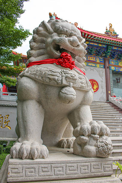 istock lion stepping world as stone statue at front chinese temple 482968886
