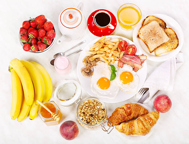 istock Breakfast  with fried eggs, coffee, orange juice, toasts and fruits 482969210