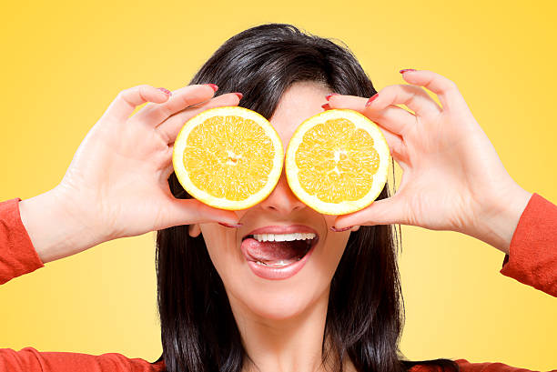 istock woman with oranges in front of your eyes 482969423