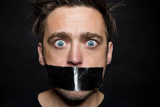 junger mann stumm - human mouth duct tape covering adhesive tape stock-fotos und bilder