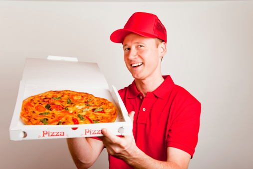 a pizza delivery boy is showing you a tasty pizza