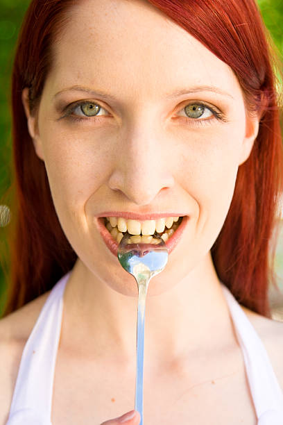 istock woman holding a spoon 482970953