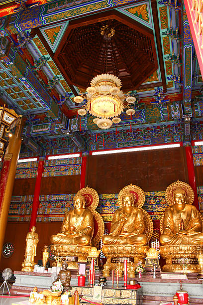 istock Three buddha sculpture sitting in temple as vertical 482975554