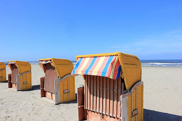 Roofed wicker beach chairs. Egmond aan Zee, North Sea, Netherlands. stock photo