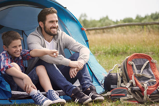 istock Father and son resting outside the tent 482983140