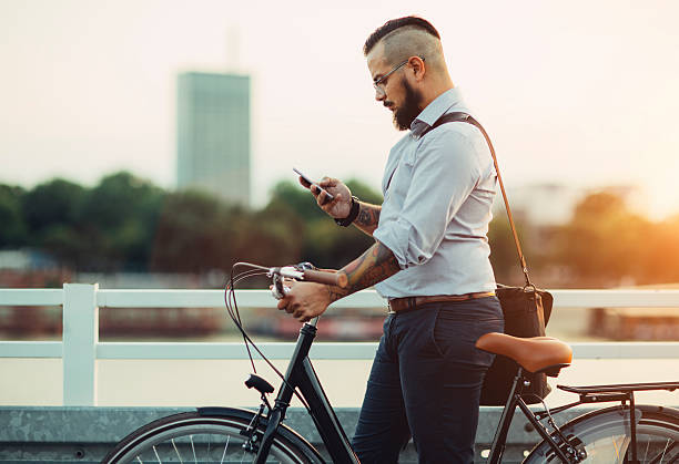 istock Businessman Push Bicycle and Using Smartphone Outdoors. 482983364