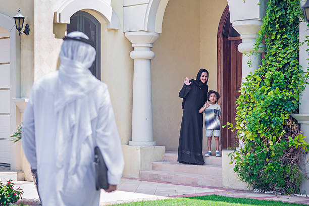 istock Mother and son welcoming father coming back home. 482984340