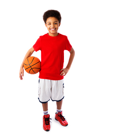 African American smiling teenager, basketball player posing with a ball in his hand isolated on white background. Full body portrait.