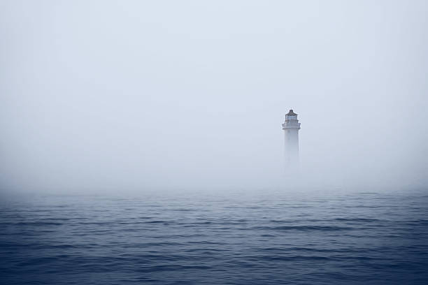 Lighthouse in foggy sea