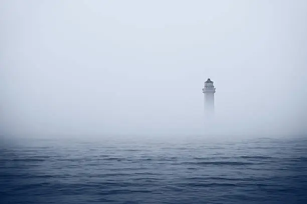 Photo of Lighthouse in foggy sea