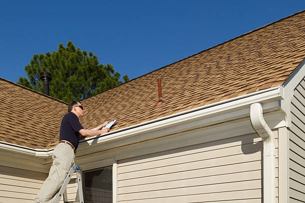 Home inspector examines a residential roof vent pipe. Inspector on a step ladder inspects a roof vent on a home. quality stock pictures, royalty-free photos & images