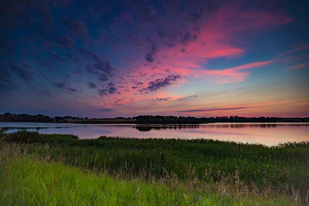 istock Summertime landscape with sunset over lake 482987946