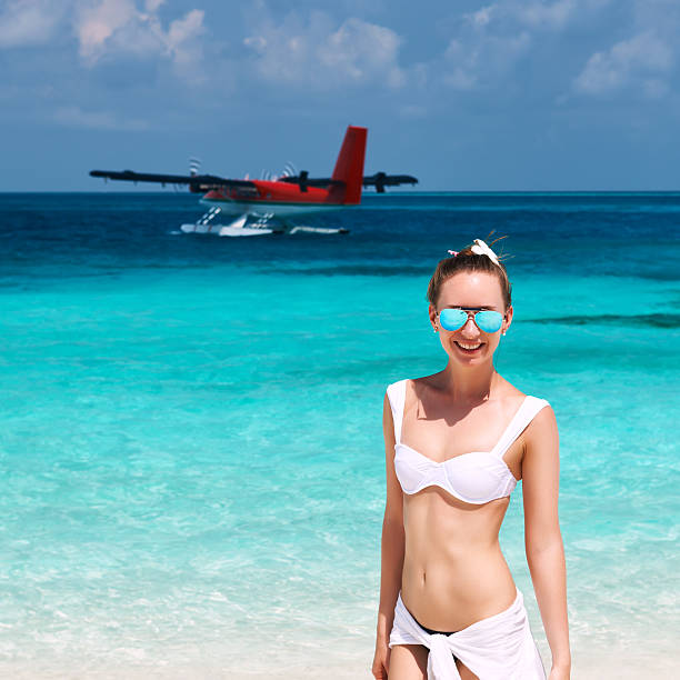 istock Woman at beach. Seaplane at background. 482988421