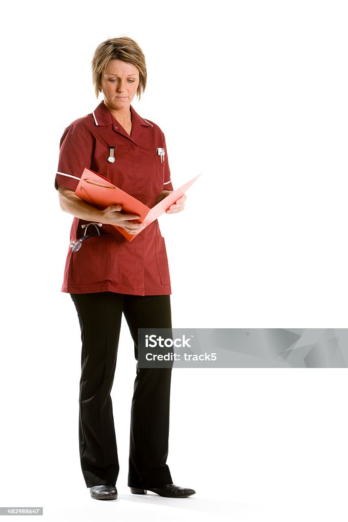 healthcare: nursing notes A nurse checks over her patients notes. Nurse Stock Photo