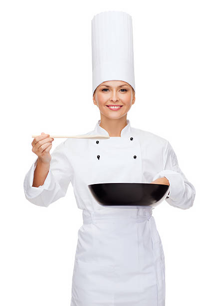 chef sonriente mujer con pan y la cuchara - women spoon tasting elegance fotografías e imágenes de stock