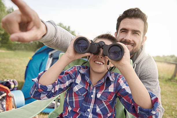 istock Father showing son the world via binoculars 482988768