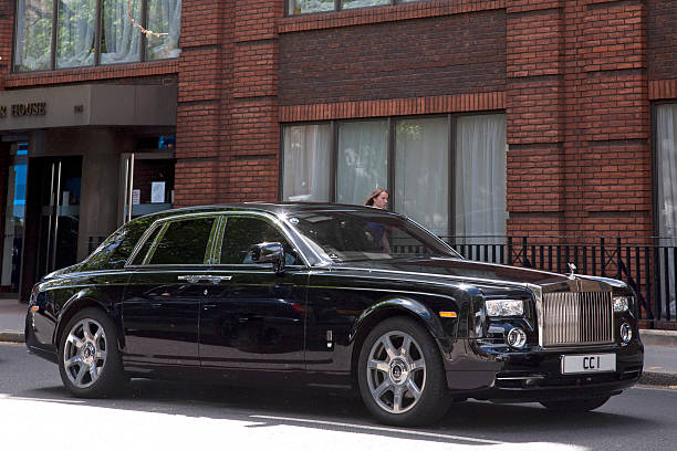 Rolls Royce Phantom London, England, UK- May 9, 2011: A black Rolls Royce Phantom super luxury car on the streets of London England with a woman walking on the sidewalk in the background. Rolls-Royce Phantom stock pictures, royalty-free photos & images