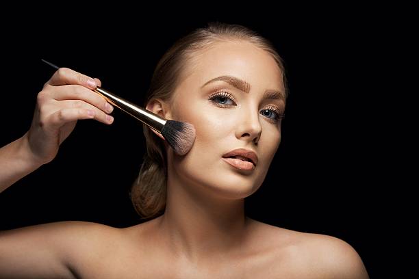 istock Attractive young woman applying make up 482992767