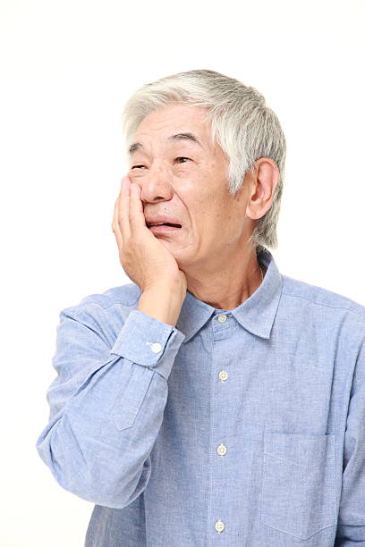 istock senior Japanese man suffers from toothache 482998244