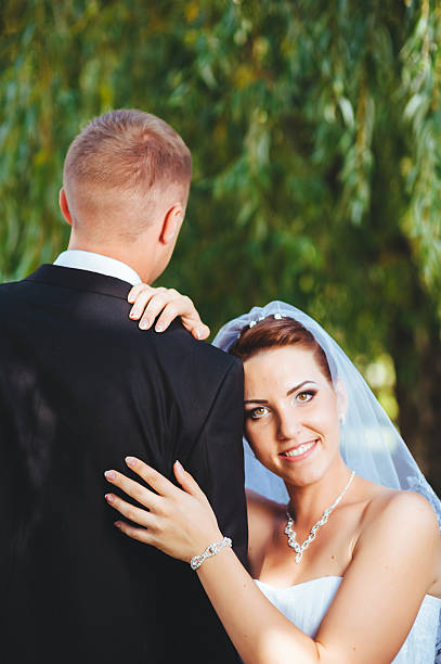 istock Bride and Groom at wedding Day walking Outdoors, embracing in 483004618