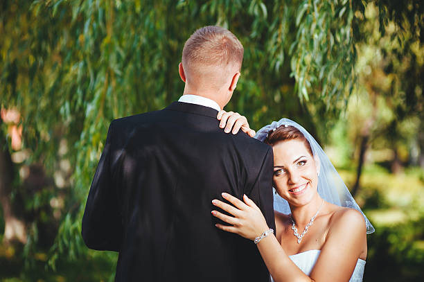 istock Bride and Groom at wedding Day walking Outdoors, embracing in 483005354