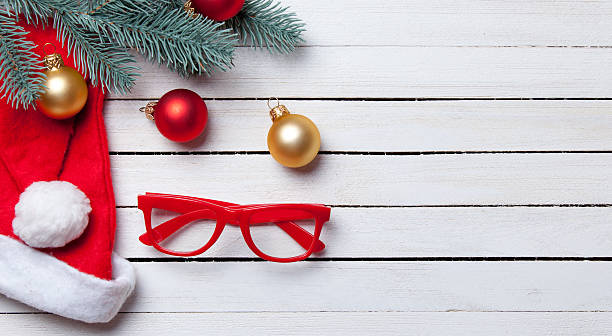 istock Santas hat and christmas bubbles with red glasses 483005654