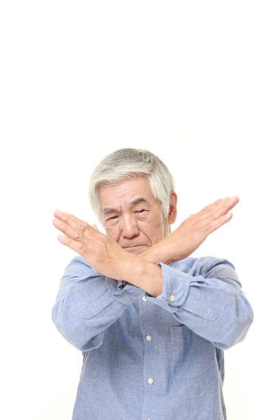 istock senior Japanese man making NO gesture 483010716