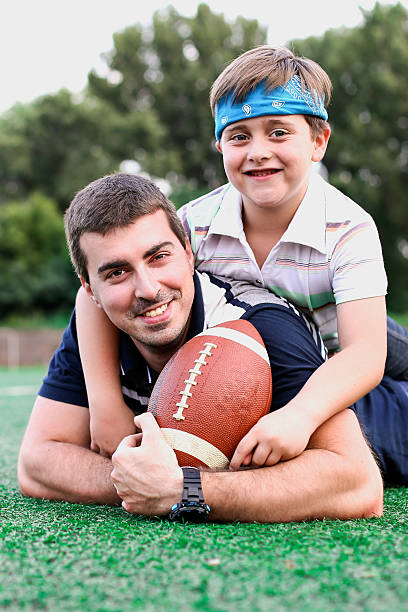 istock Father and son playing American football 483014134