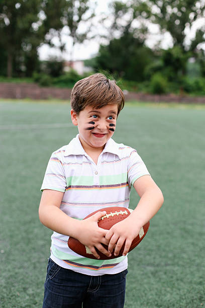 istock Happy boy playing with a rugby ball 483014140