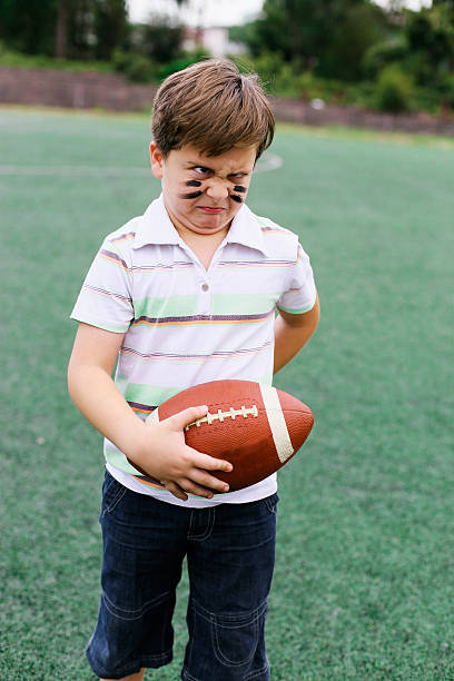 istock Football boy makes a face 483014144
