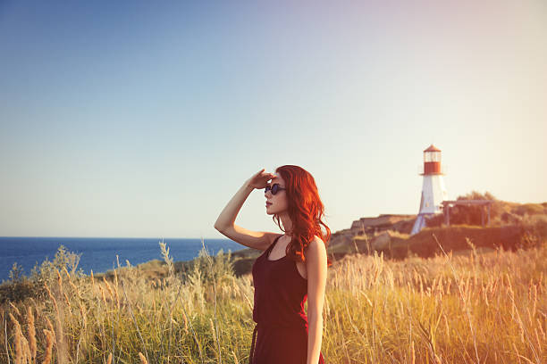 istock girl with sunglasses near Lighthouse 483014180