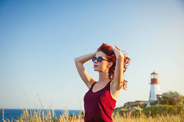 istock girl with sunglasses near Lighthouse 483014218
